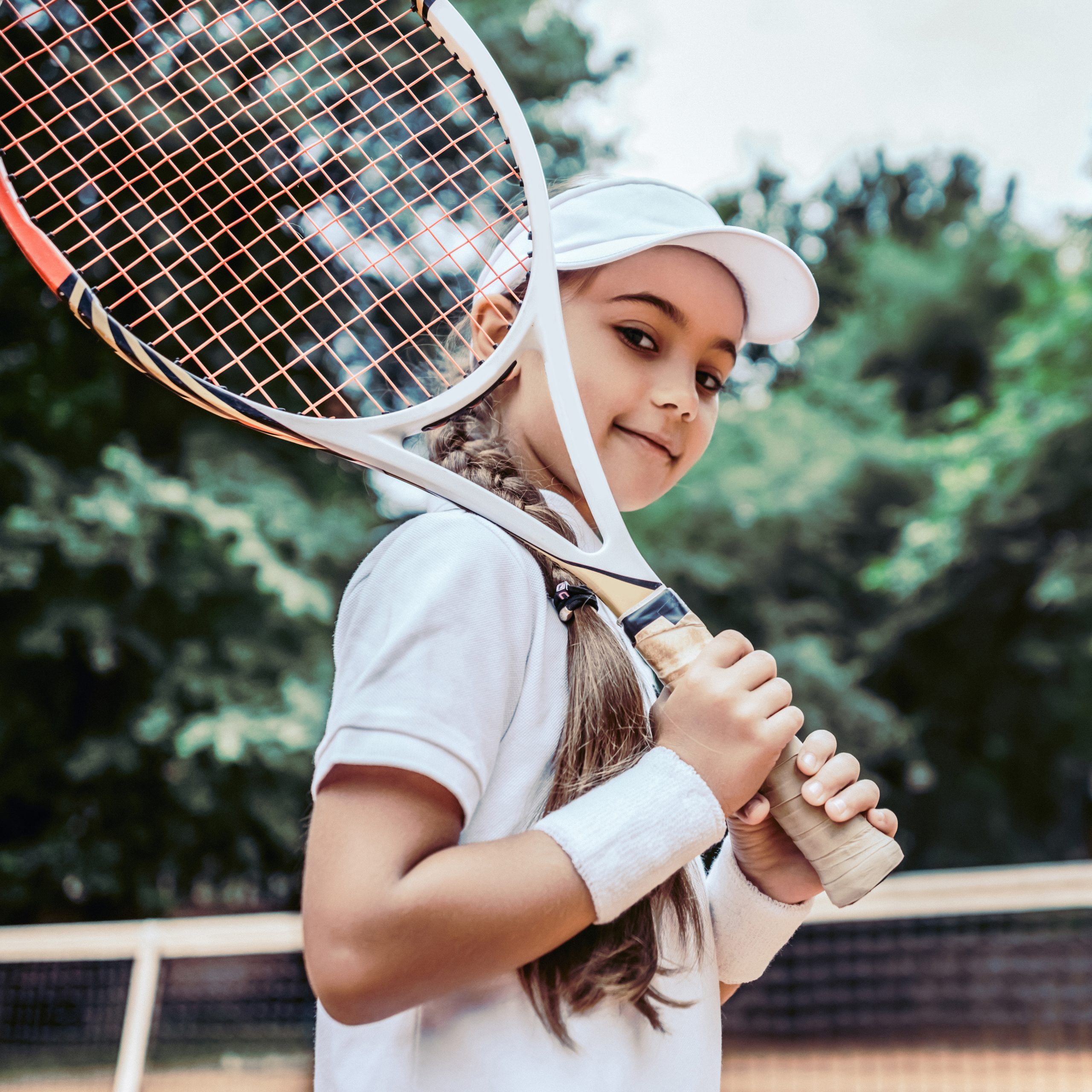 Tennis training for young kid outdoors. Portrait of happy sporty